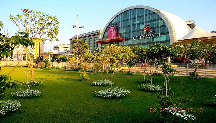 Greenery is in front of the Select Citywalk Mall, a top-rated mall in Delhi.