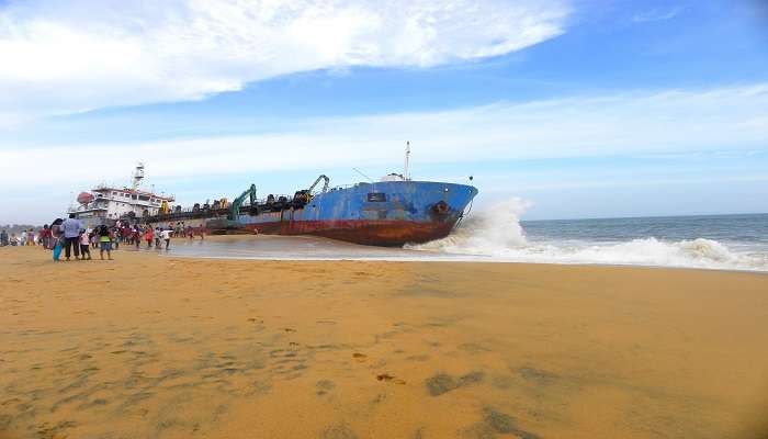 A surfer in action on a wave, Munakkal Beach.