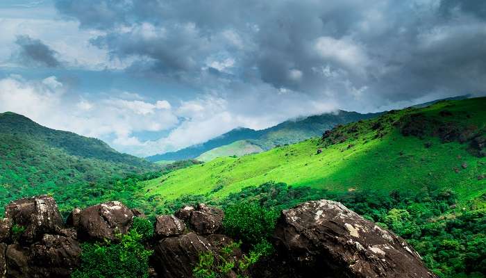 Mountain gap with river flowing and green forests near Honnamana Kere