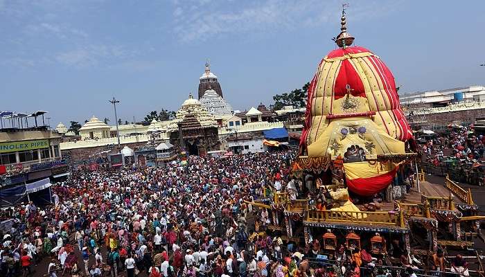 A religious festival procession taking place near the Jagannath temple at Puri