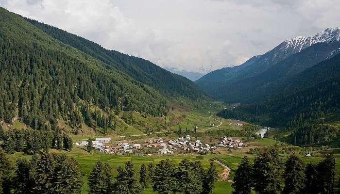 Entrance to Aru Village with scenic pathway leading into the picturesque mountainous landscape near Wadiy e Hajan