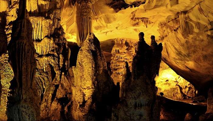 Entrance of Dupnisa Cave surrounded by dense forests. 