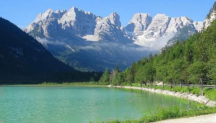 View of the Dolomites and green pastures from Lake Landro