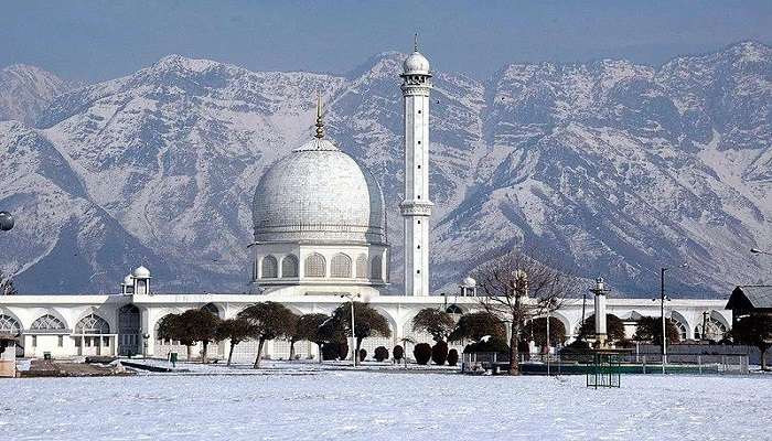 Front view of Hazratbal Shrine in Srinagar, showcasing its pristine white marble facade and domed structure