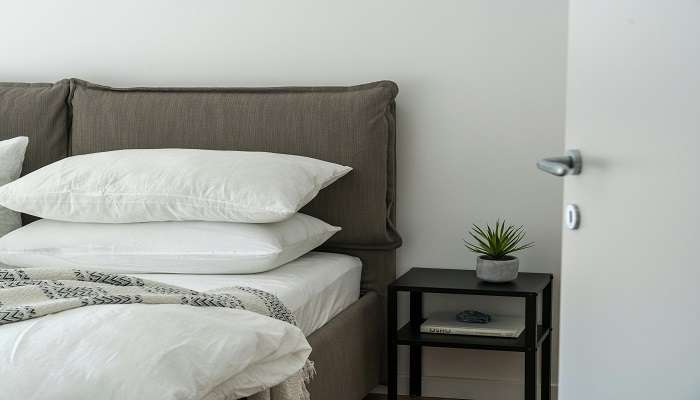 White linen on bed in a hotel in Kotdwar.