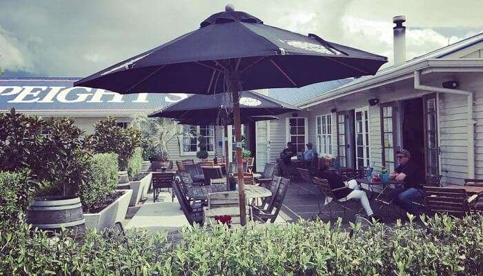 People sitting outdoors on a sunny day at Jolly Stockman Hotel.