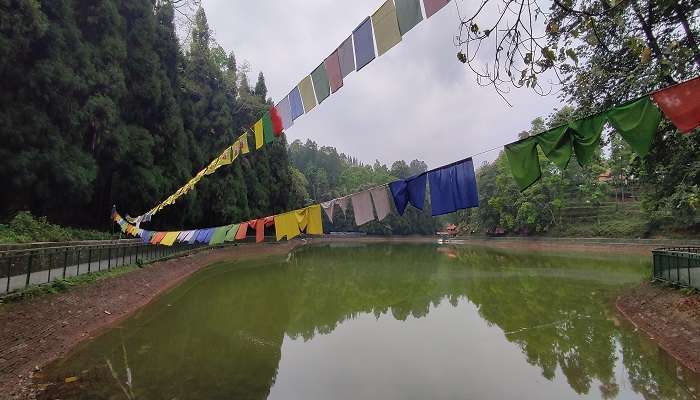 Colourful Flags fluttering over the quaint Lampokhari Lake