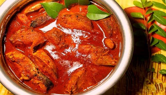 A plate of Kerala Fish Curry, a famous dish to try near the Peechi Vazhani Wildlife Sanctuary.