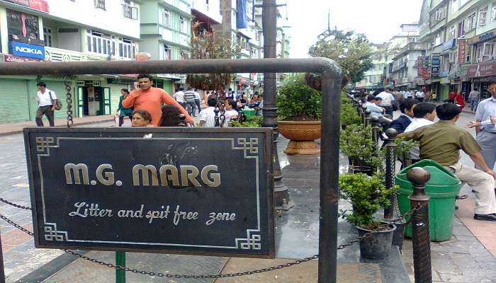 Tourists sitting at the benches at MG Marg.