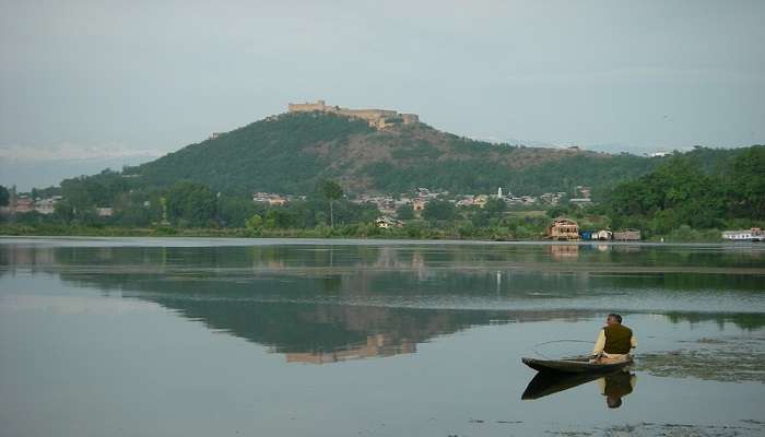 Panoramic view of Jingbo Lake with serene waters and lush landscape close to Salim Ali National Park