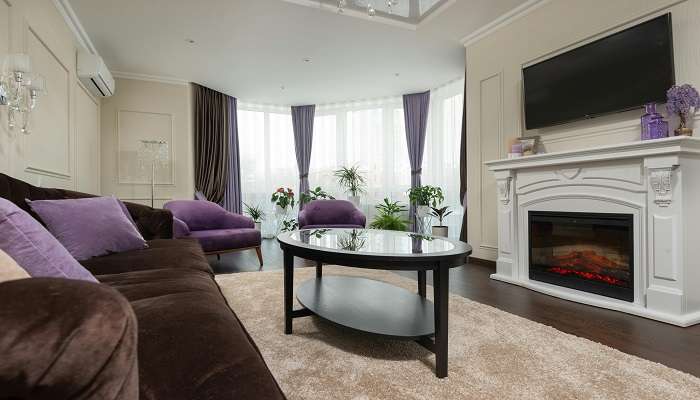 A Cosy Couch and Center Table Near the Fireplace to stay at the best Hotels in Bendigo.