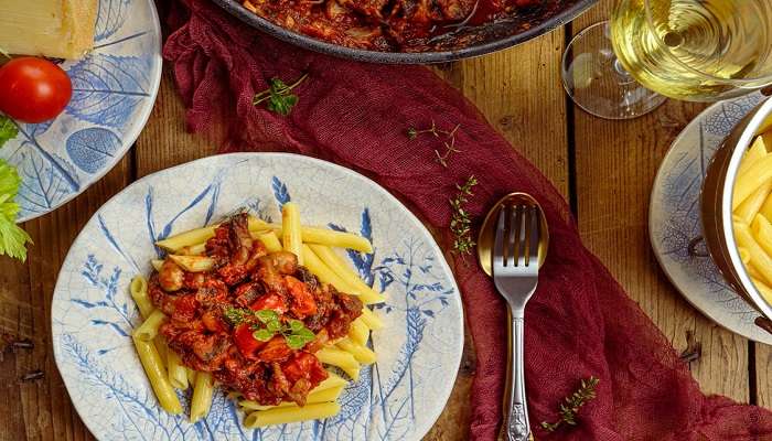 Pappardelle alla Greppia, an appetising Italian pasta dish prepared with cheese and olive oil served on a plate at the best restaurants in Verona.