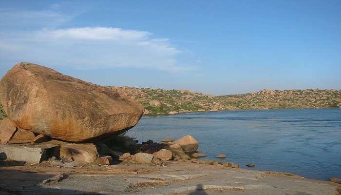 Serene Sanapur lake surrounded by boulders