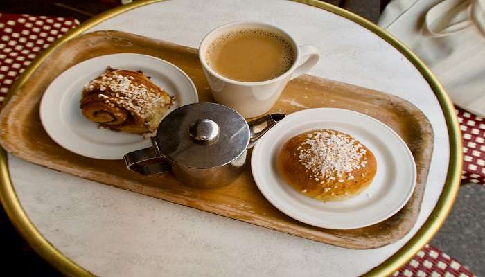 A cup of coffee in brown wooden tray