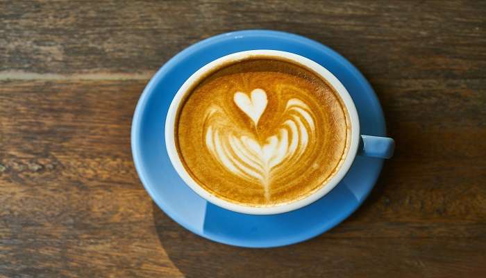 A hot cup of coffee on table at the best cafes in Swan Hill.