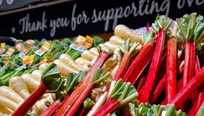 A variety of fresh fruits and eggs are displayed at the shop in a clean surrounding