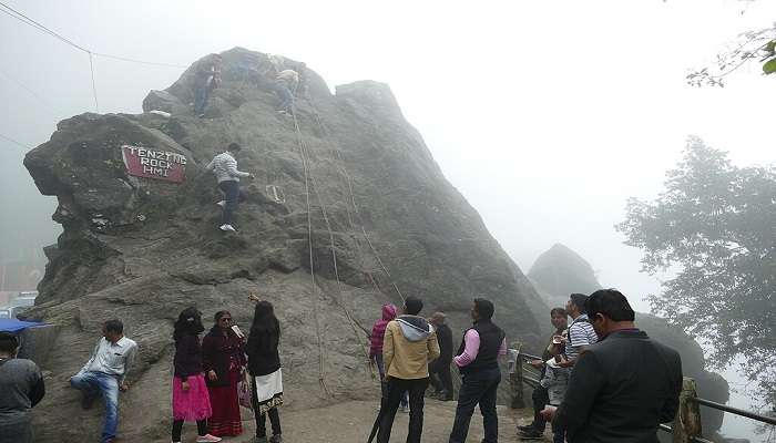 Visitors climbing Tenzing Rock Darjeeling.