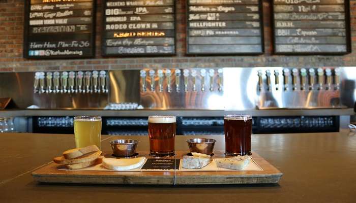 three Glass Cups on Brown Wooden Tray With Pastries at the top pubs in Bathurst.