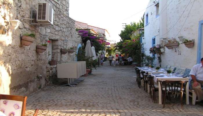 Picture-perfect stone houses, narrow cobblestone streets and busy cafe 