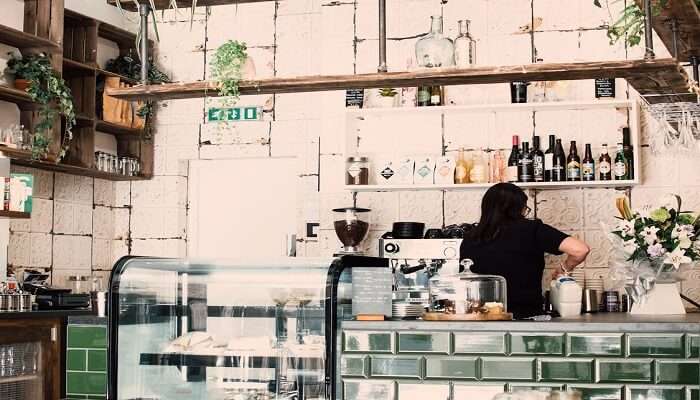 A woman preparing a cup of coffee