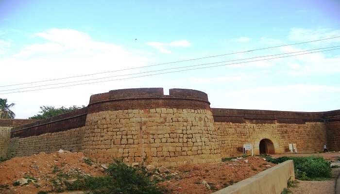 An ancient fort structure remains inside Devanahalli Fort, and its surroundings are filled with wildly grown vegetation. 