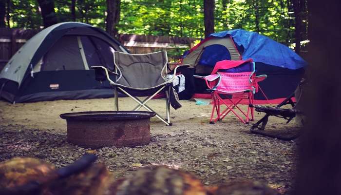 Tourist campers in Pangot maintain safety measures while pitching their tent at the site.