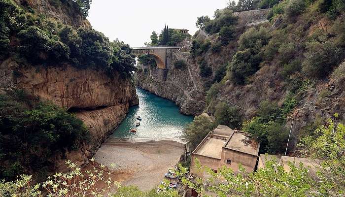 A view from the fjord with the settlement above with a path leading into the valley floor near the Amalfi Coast Italy.