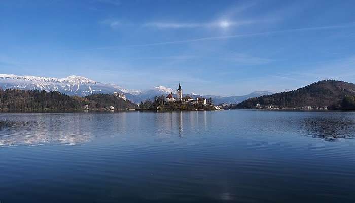 Serene autumn landscape of Lake Bled reflecting vibrant colours