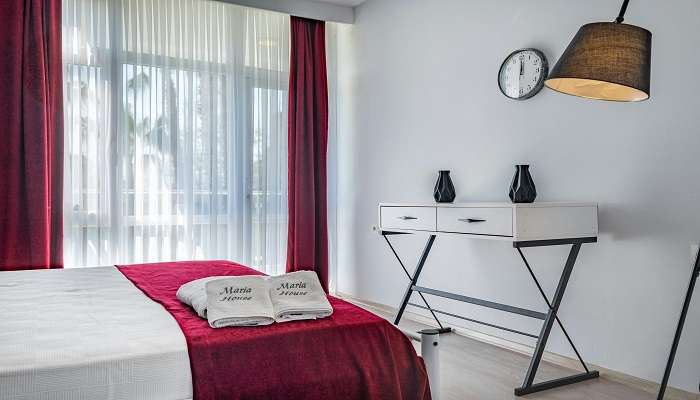 White bath towel on the bed of a hotel room 