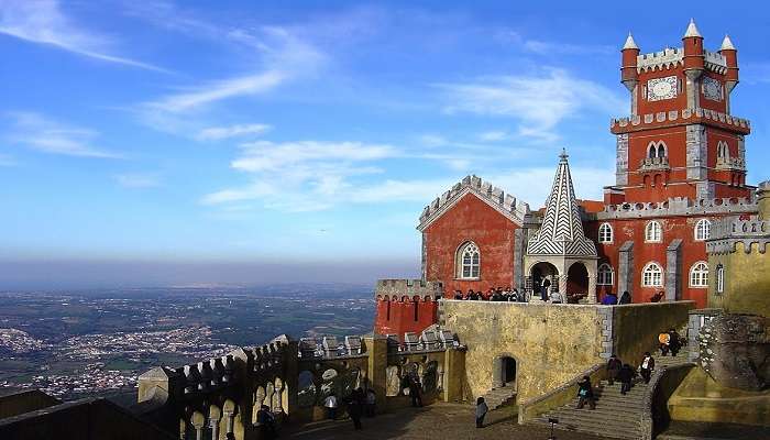 Majestic view of the National Palace of Pena perched on a lush hill in Sintra