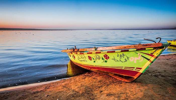 Explore a traditional boat floating in Faiyum's serene waters