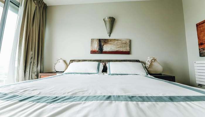 A white bed in a hotel room, Hotels in Perambur