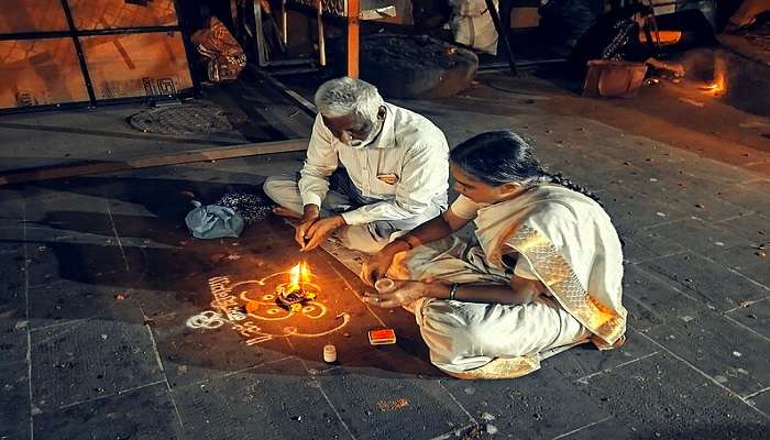 Devotees performing puja at the temple