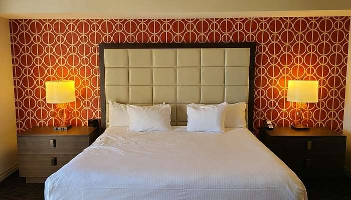 Staff making the bed of a hotel room, Hotels In Royapuram