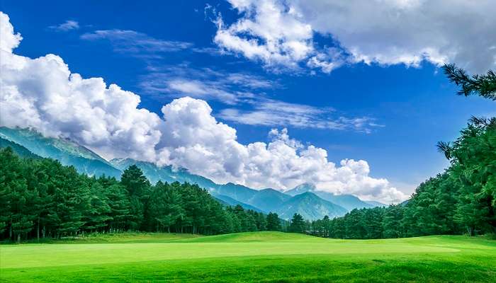 Aerial view of the 18-hole Pahalgam Golf Course shows well-manicured greens and fairways in majestic Himalayan mountains near the Tulian Lake.