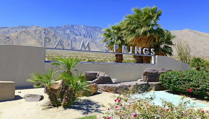 Palm Springs sign with desert background, California