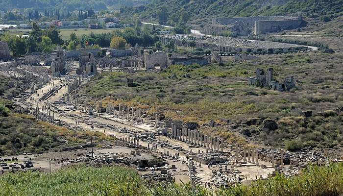 Exploring ancient ruins with a view of Perge city 