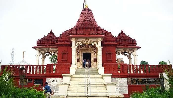 Devotees offering prayers at the inner sanctum of Naulakha Temple.