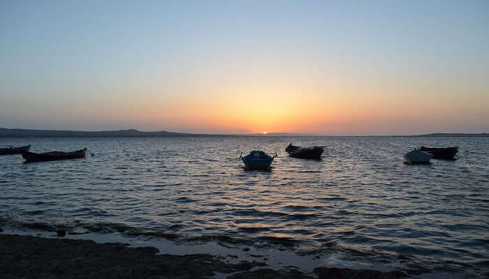 Sea boats during sunset at Patata Beach