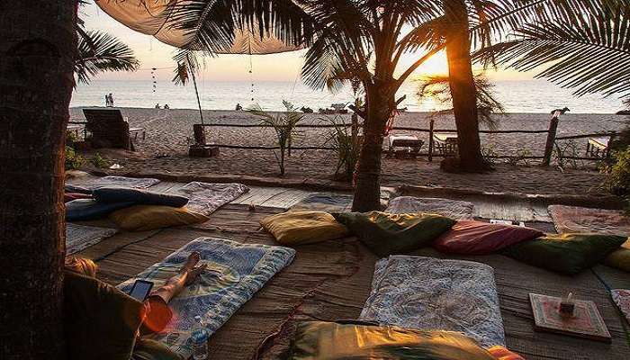 Wide stretch of Agonda Beach with golden sand shore and blue water.