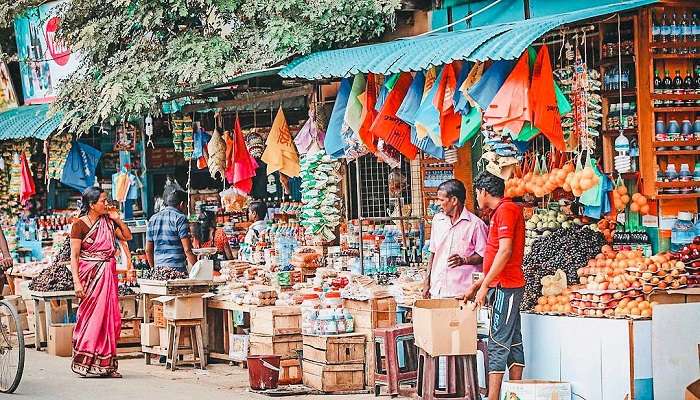 Man holding red chilli peppers in his hand at Jaffna Market near Dambakola Patuna Sangamitta Temple