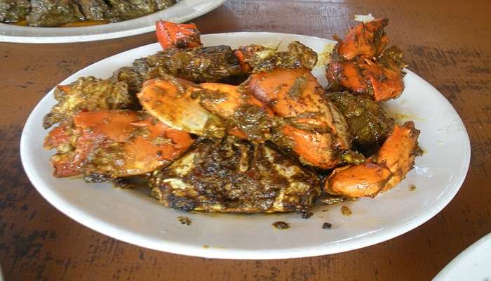 In frame is a local delicacy of sea crabs cooked in a spicy gravy