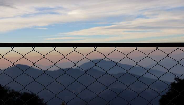 Sunrise image of Hattu Peak with clouds covering most of the hills