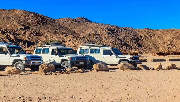 Desert safari trip with vans heading to the Bedouin village