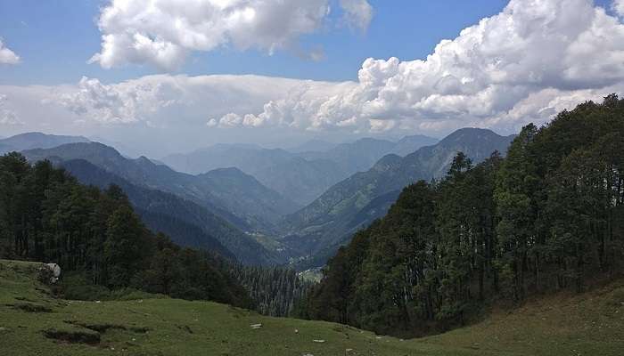 Jalori Pass, snow-covered, with trekkers in the front and faraway mountain views