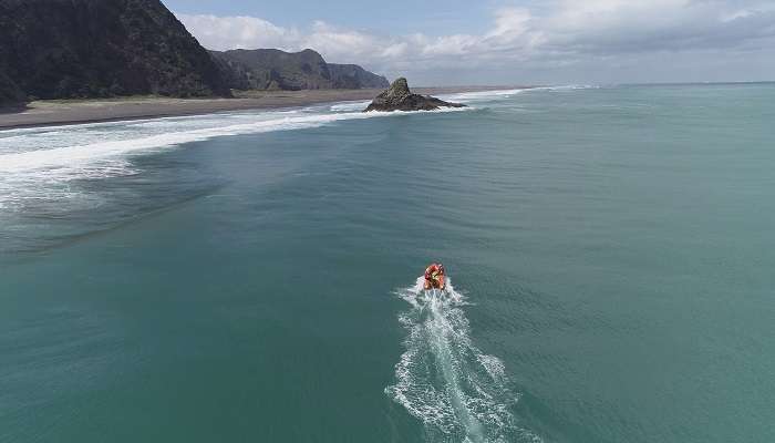 A diagonal shot facing westward from Karekare Beach, showing the waves and a rather indistinct horizon.