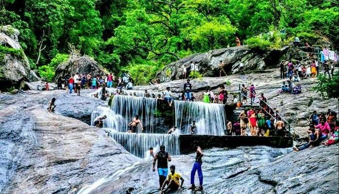 Kovai Kutralam Falls, a beautiful waterfall located in the Siruvani Hills, Coimbatore, surrounded by lush greenery.