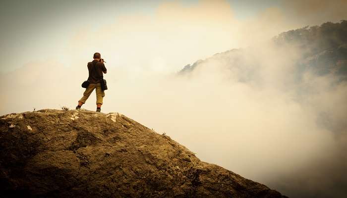 a photographer capturing the beauty of mountains