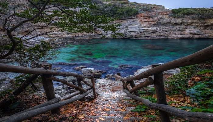 Bagni della Regina Giovanna is a natural swimming pool surrounded by cliffs 