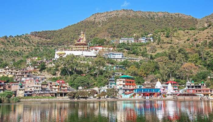 Scenic Rewalsar Lake amidst hills and religious buildings